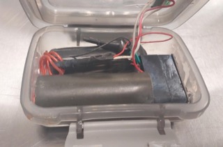 Batteries and wires inside a clear plastic box