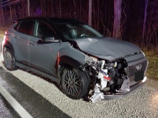 Damaged gray SUV with front-end collision