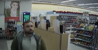 Man walking in a store aisle.