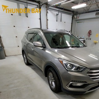 Silver Hyundai Santa Fe in a garage