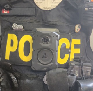 Police body camera and accessories attached to a uniform.
