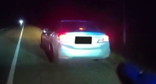 Car with flashing red and blue lights. License plate obscured.