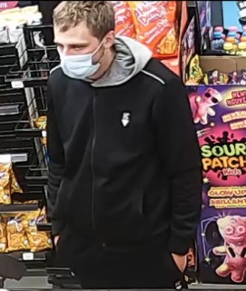 Person wearing a black hoodie and face mask.