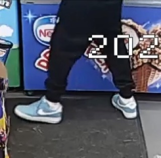 Person wearing black sweatpants and light blue and white sneakers