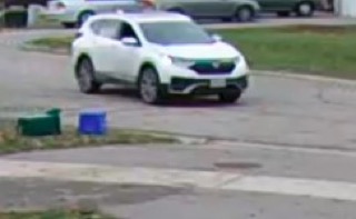 White SUV on a street.