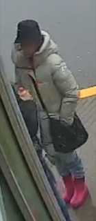 Person in a puffer jacket and pink boots.