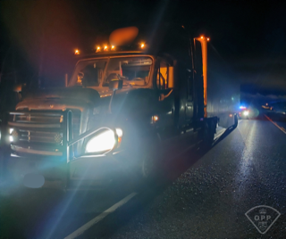 Towing truck on a wet road at night