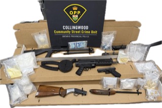 Firearms and Canadian currency on a wooden surface.