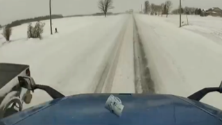 Snow-covered road stretching into the distance