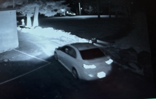 Car parked on a dark street.