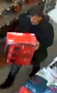 Person holding a red gift box