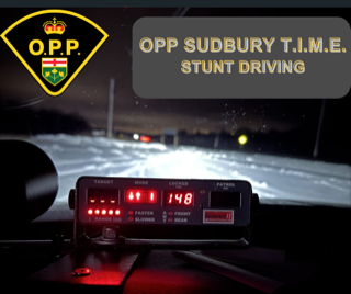 Dashboard display showing speed of 148km/h, OPP logo, text: OPP SUDBURY T.I.M.E. STUNT DRIVING