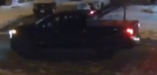 Black pickup truck, rear view, nighttime