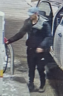 Person filling a gas pump