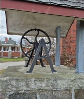 Old well with a metal wheel.