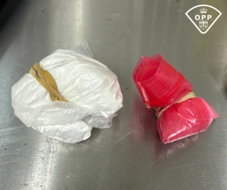 Two packages wrapped in plastic, secured with twine.