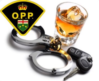 Handcuffs, car keys, and a glass of amber liquid with ice