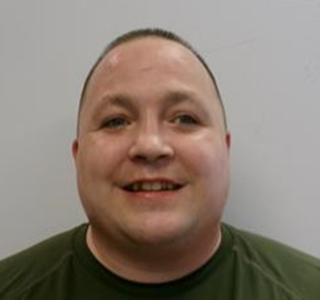 Man smiling, dark t-shirt