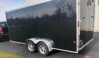 Black utility trailer with dual wheels