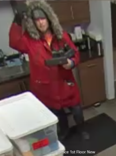 Person in a red coat and fur-trimmed hood.