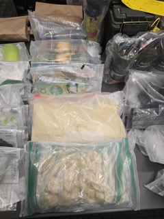 Green bundles of cash in clear plastic bags.