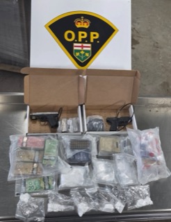 Canadian currency and a handgun in a box.