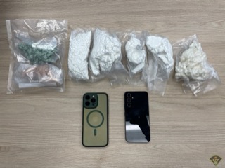 Two smartphones, one gold, one black, next to food storage bags.