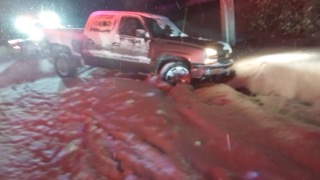Red pickup truck stuck in snow