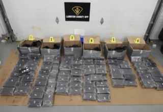 Packages of suspected drugs on a white surface.