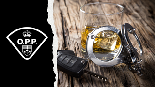 OPP emblem, handcuffs, car key, glass of whiskey