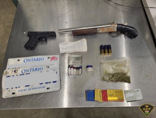 Firearm and drug paraphernalia on a metal surface.