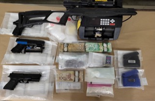 Assault rifle, handgun, cash, and baggies