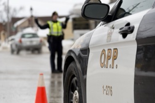 OPP police vehicle, officer directing traffic