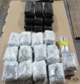 Stacked packages of a dark substance, some labeled &quot;WEIRD&quot;