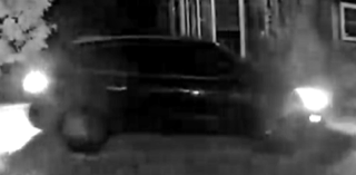 Black car, blurry, headlights bright